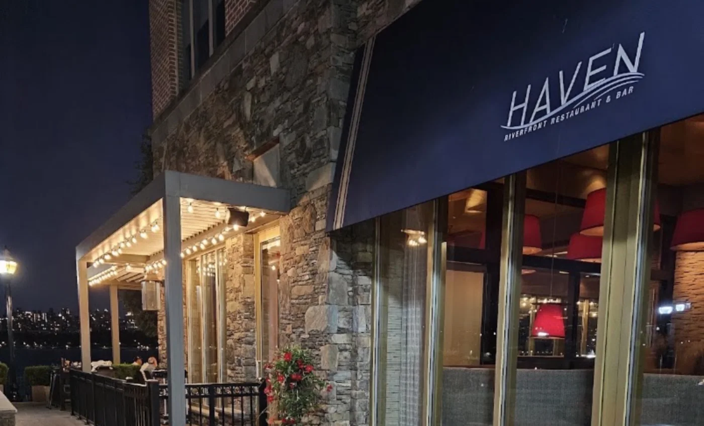HAVEN Riverfront Restaurant and Bar storefront at night with lit pergola and dining terrace