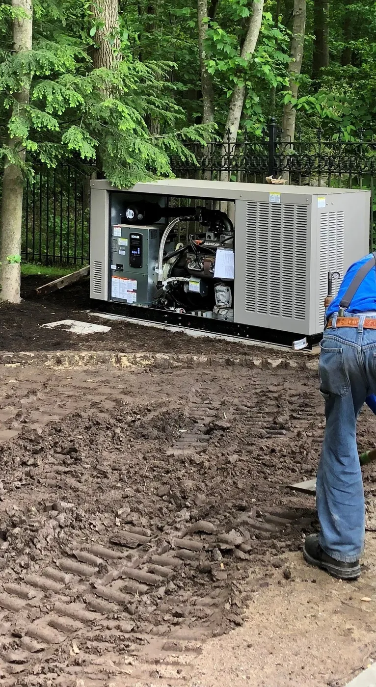 Sixty kilowatt standby generator set on a concrete pad during commissioning