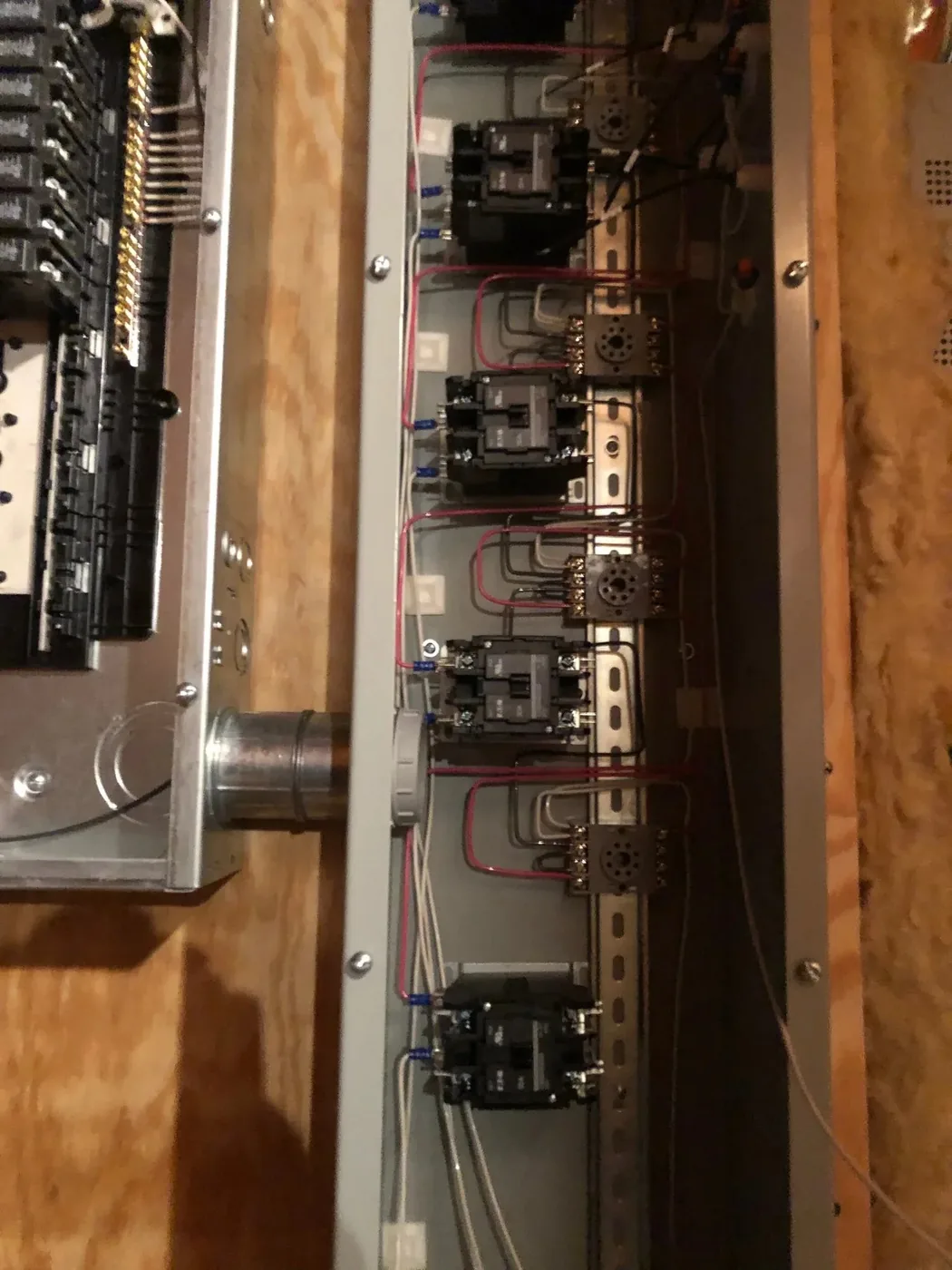 Open distribution panel showing feeder breakers and terminations during service work