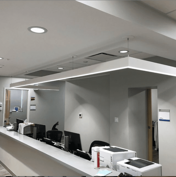 Completed clinical work station with recessed lighting, soffit detail, and equipment power